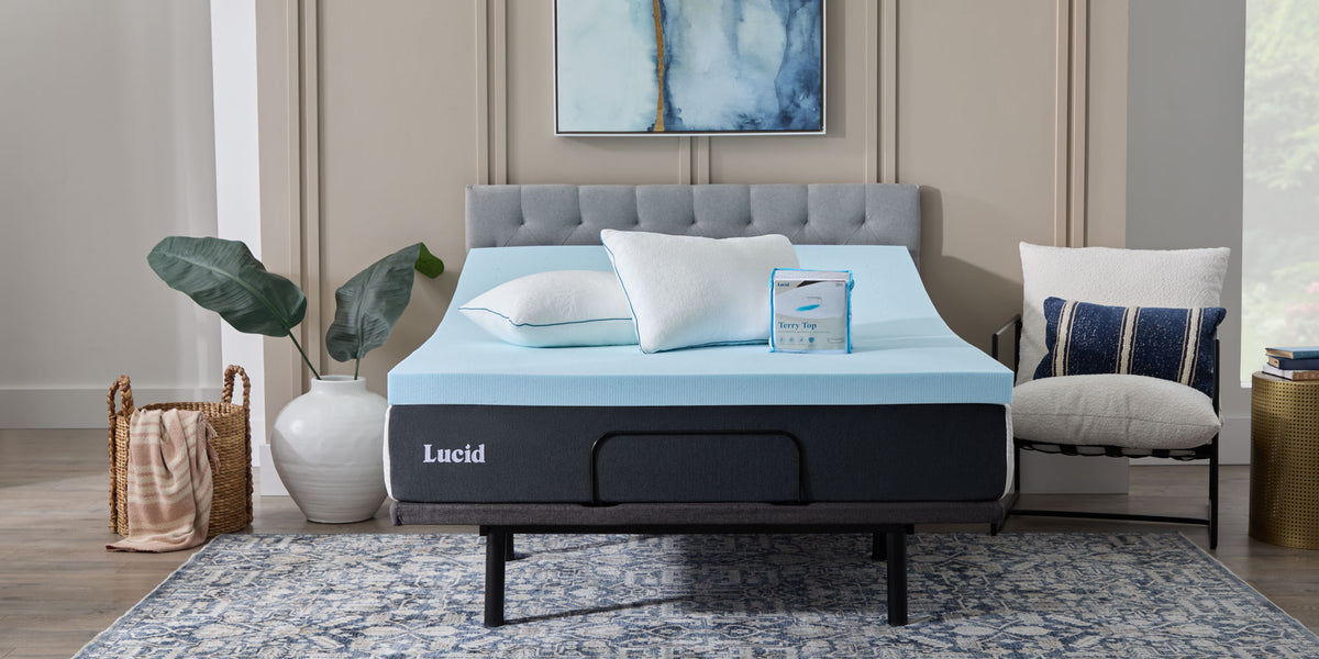 A Lucid memory foam mattress styled on a bed with a teal upholstered headboard and two accent pillows.